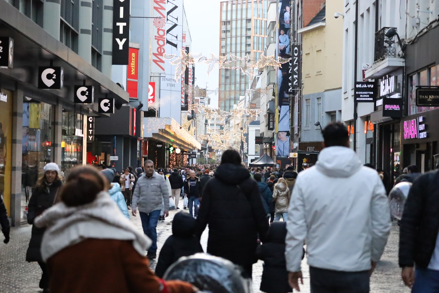 A crowded shopping street under Christmas lights, the season that breaks the budget rule